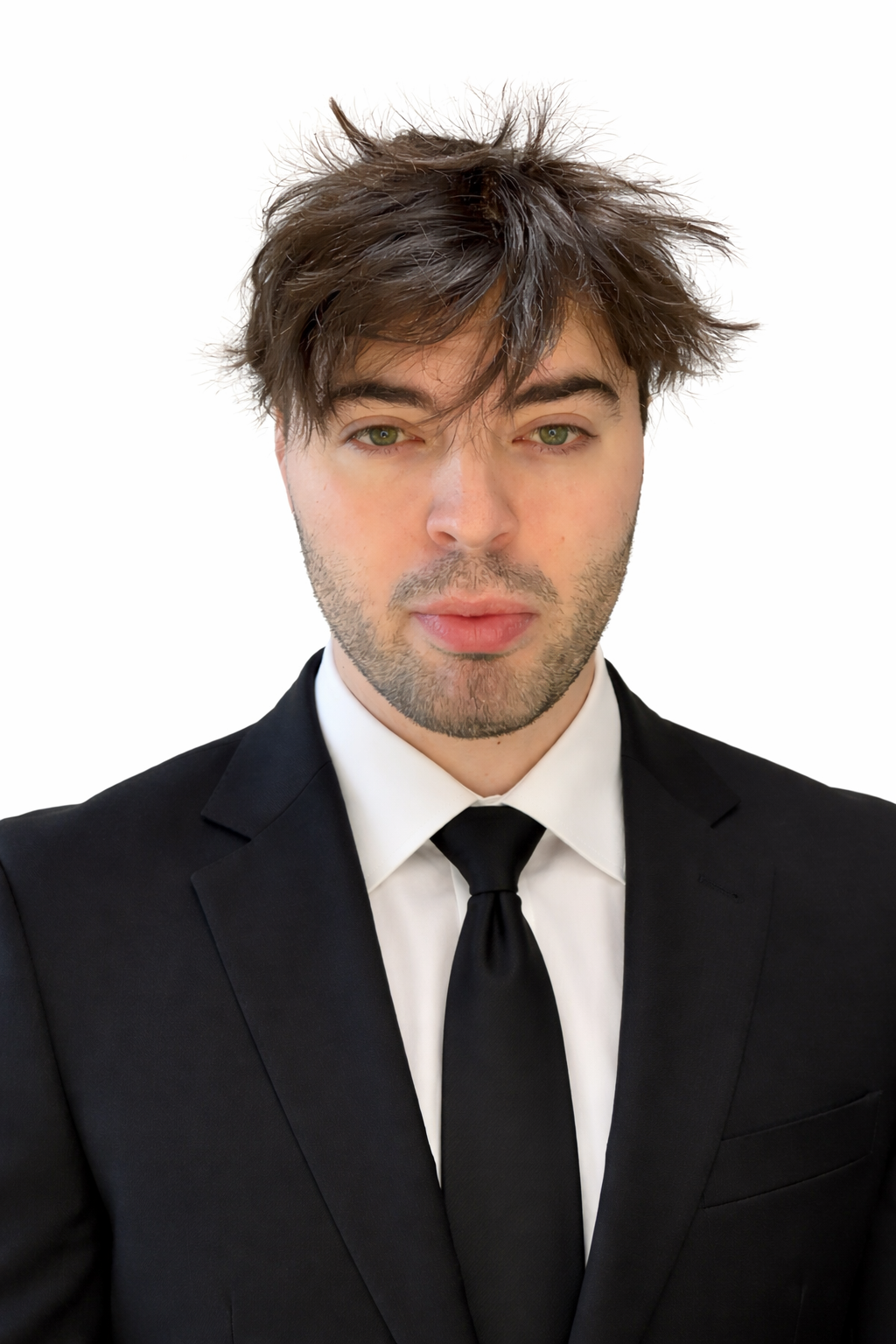 Tieran, owner of the business, wearing a black suit and tie against a white background.